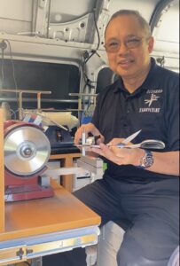 Eric Ho of BeSharp Sharpening sharpening a pair of sewing scissors.