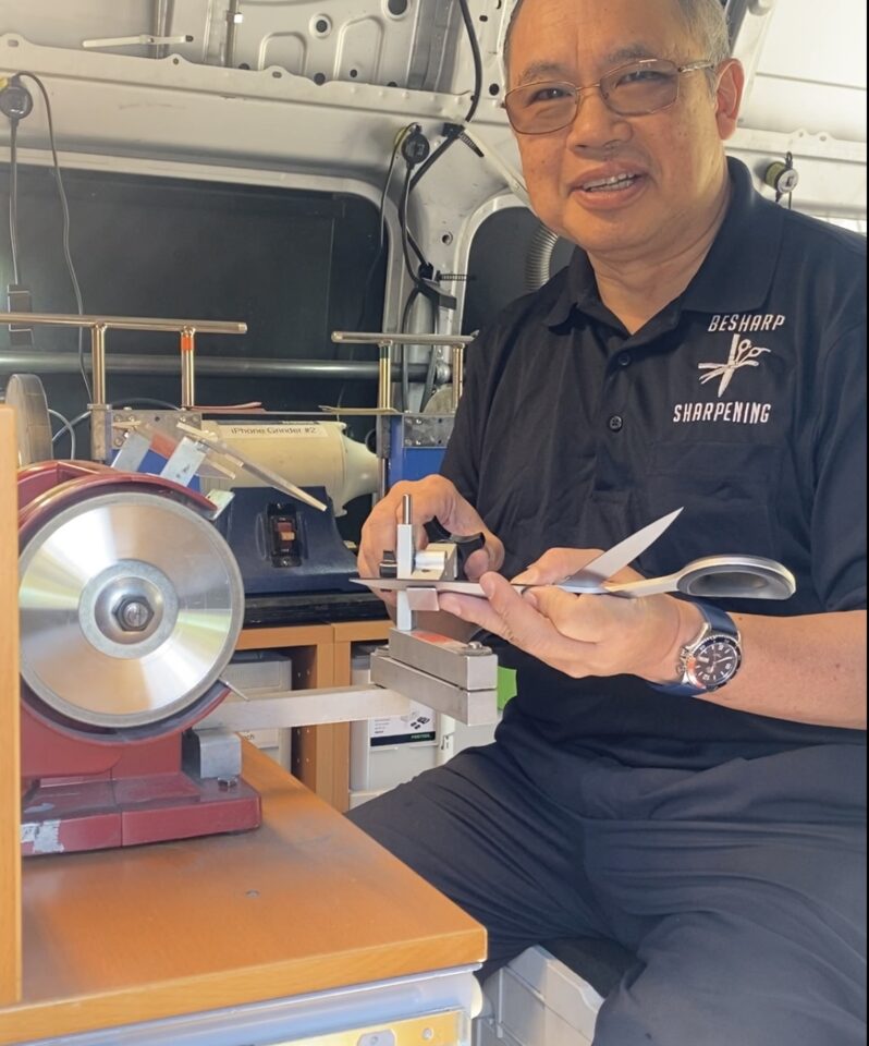 Eric Ho of BeSharp Sharpening sharpening a pair of sewing scissors.